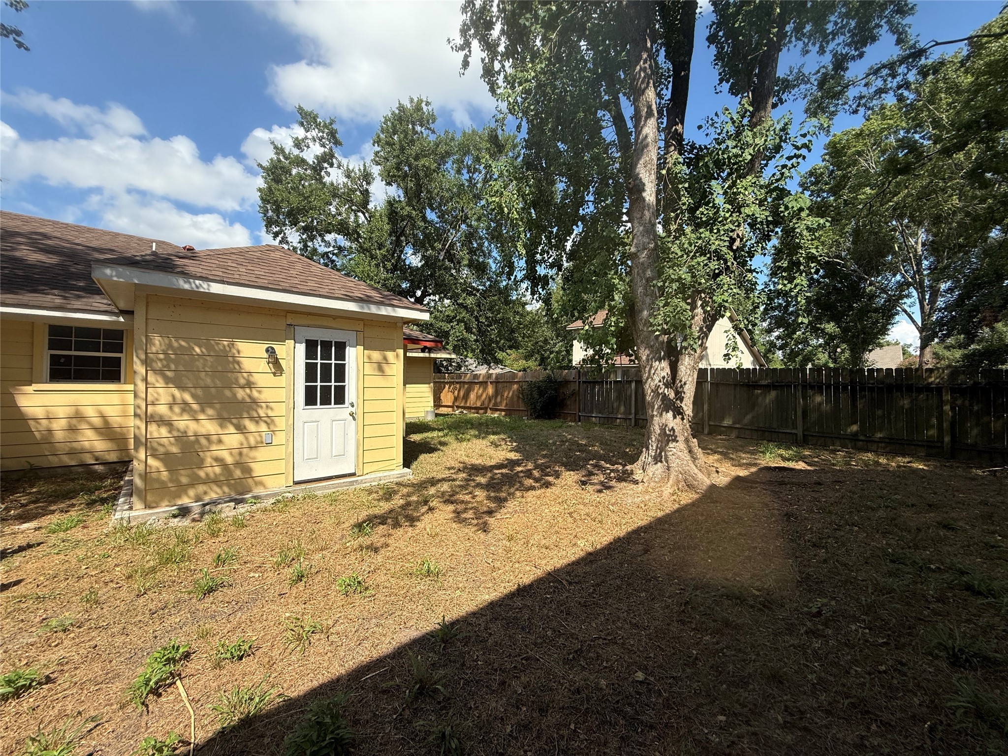 3115 Lorikeet Street Spring, TX 77373 - Photo 12 of 12 a view of a yard with a tree in the background