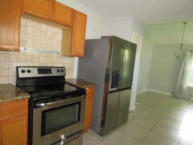 a kitchen with a stove and a refrigerator