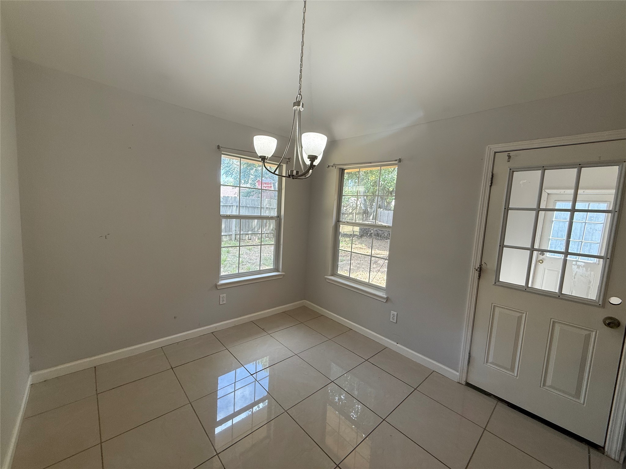 3115 Lorikeet Street Spring, TX 77373 - Photo 5 of 12 a view of an empty room with window and chandelier fan