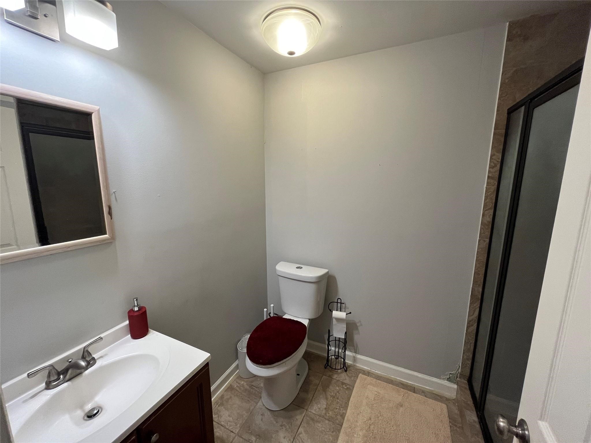 3115 Lorikeet Street Spring, TX 77373 - Photo 7 of 12 a bathroom with a sink and a toilet