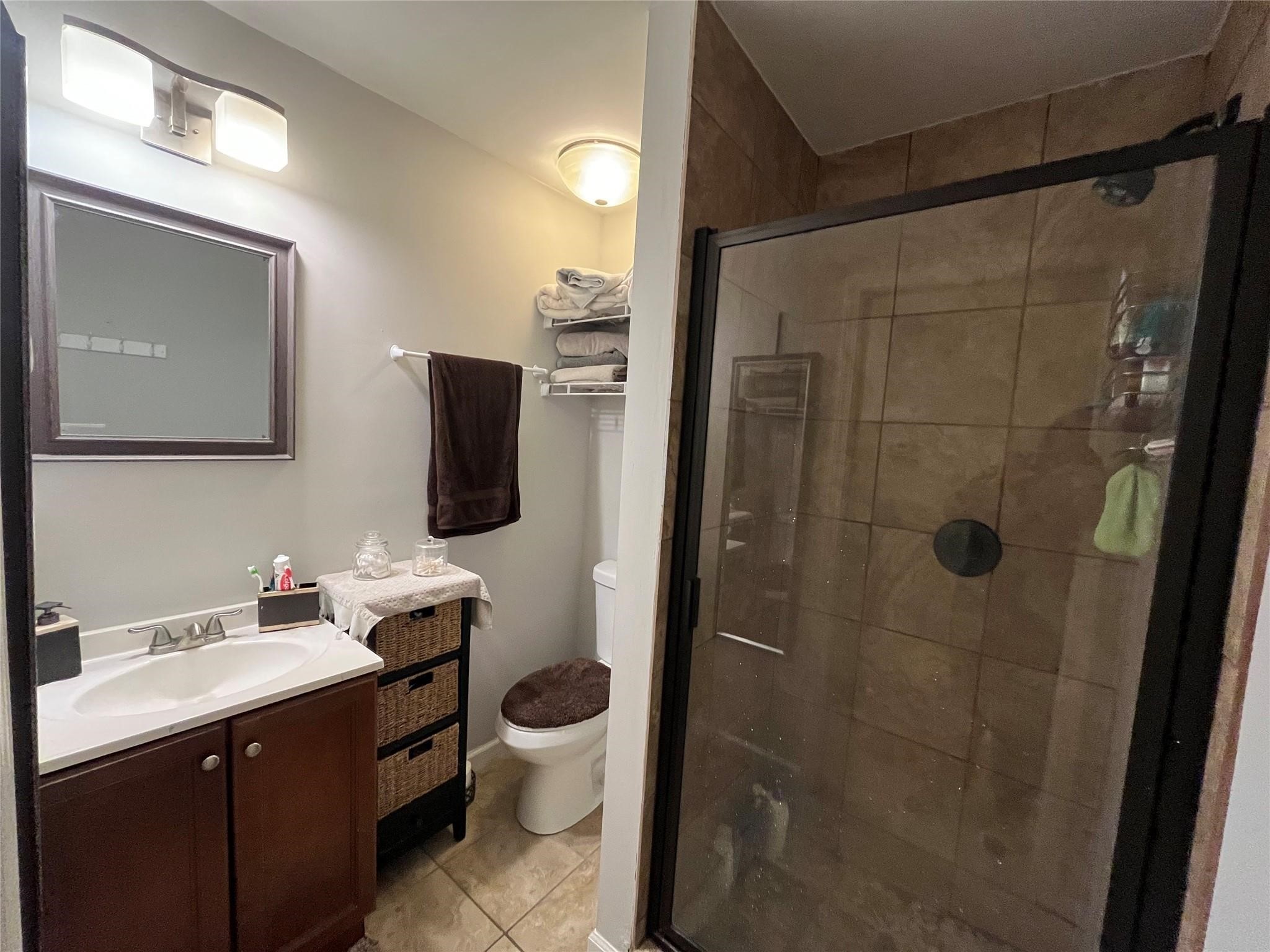 3115 Lorikeet Street Spring, TX 77373 - Photo 10 of 12 a bathroom with a toilet sink and shower