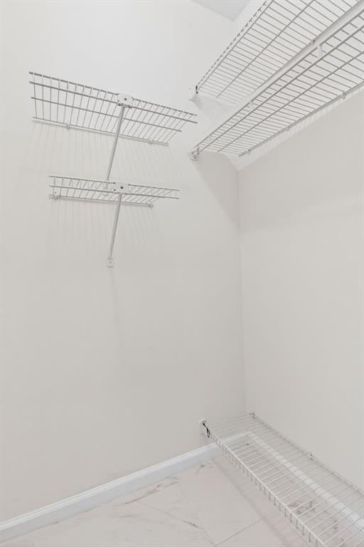 130 Cypress Club Drive, Unit 307 Pompano Beach, FL 33060 - Photo 13 of 35 a view of a room with racks on the wall