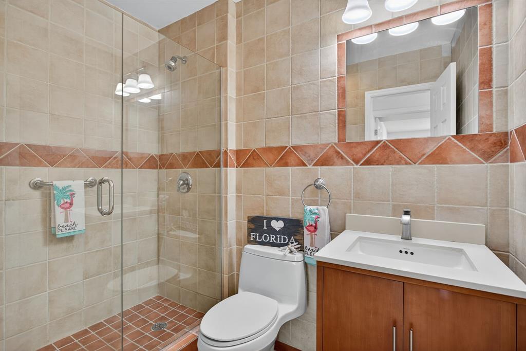 130 Cypress Club Drive, Unit 307 Pompano Beach, FL 33060 - Photo 15 of 35 a bathroom with a sink a toilet and shower