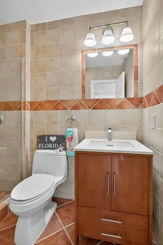 a bathroom with a sink mirror vanity and toilet