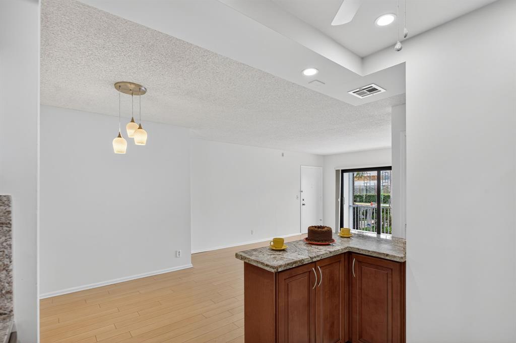 130 Cypress Club Drive, Unit 307 Pompano Beach, FL 33060 - Photo 21 of 35 a kitchen that has a sink and a stove