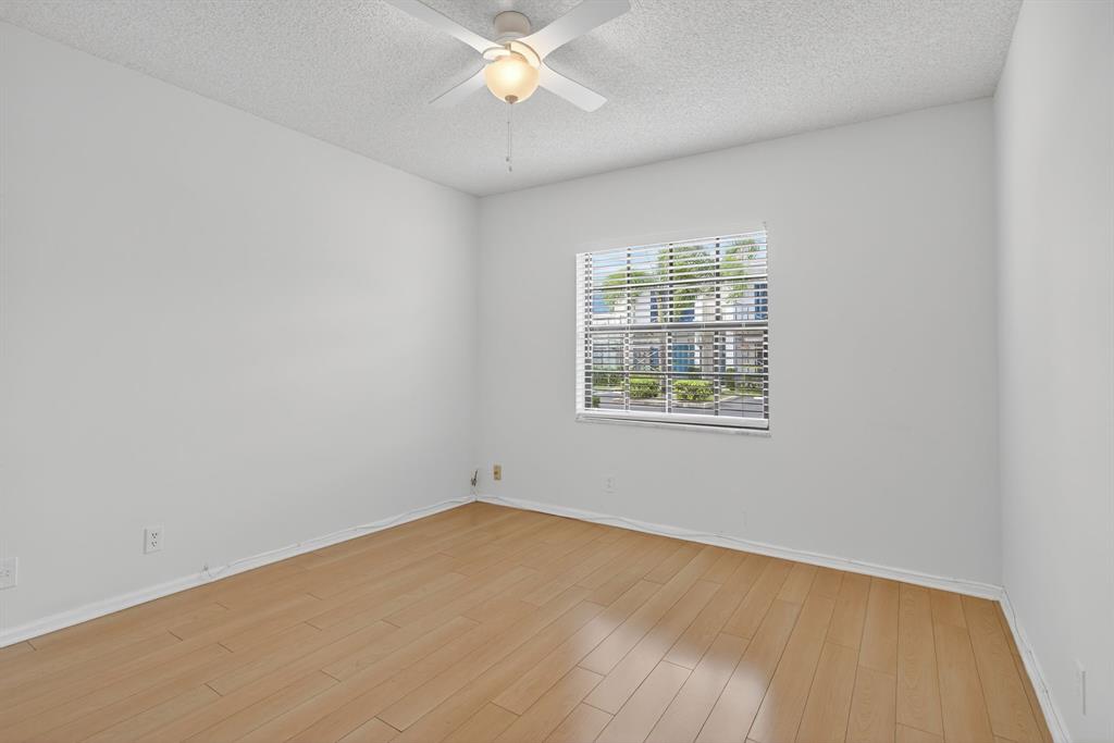 130 Cypress Club Drive, Unit 307 Pompano Beach, FL 33060 - Photo 24 of 35 an empty room with a window