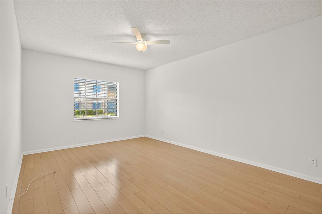 130 Cypress Club Drive, Unit 307 Pompano Beach, FL 33060 - Photo 25 of 35 an empty room with a window