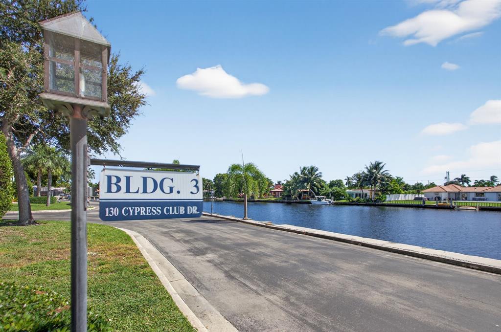 130 Cypress Club Drive, Unit 307 Pompano Beach, FL 33060 - Photo 26 of 35 a view of a street with a building in the background