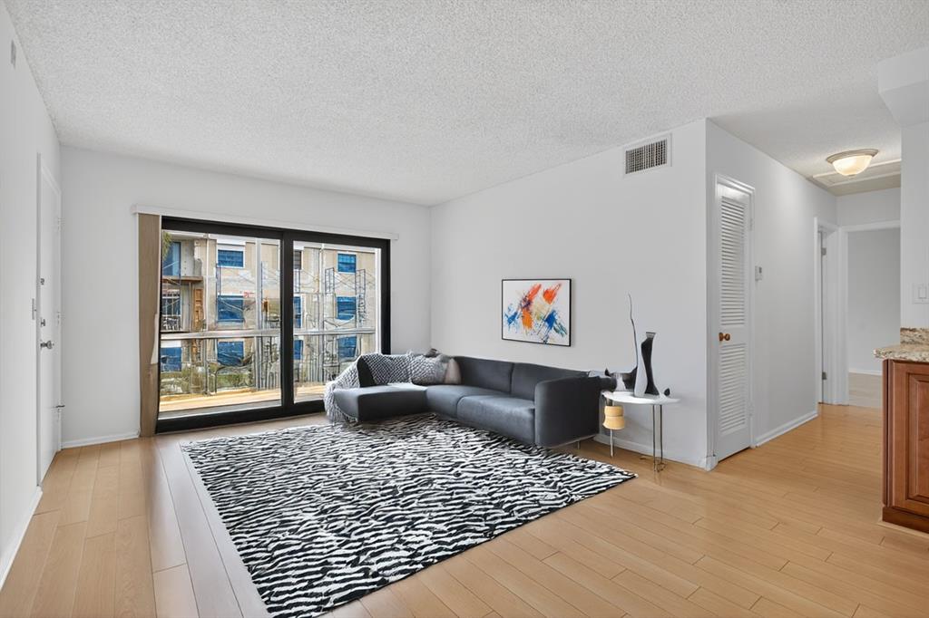 130 Cypress Club Drive, Unit 307 Pompano Beach, FL 33060 - Photo 3 of 35 a living room with furniture and a rug