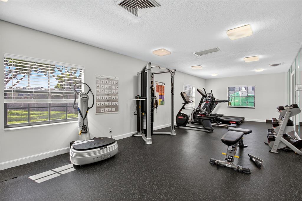 130 Cypress Club Drive, Unit 307 Pompano Beach, FL 33060 - Photo 34 of 35 a view of a room with gym equipment