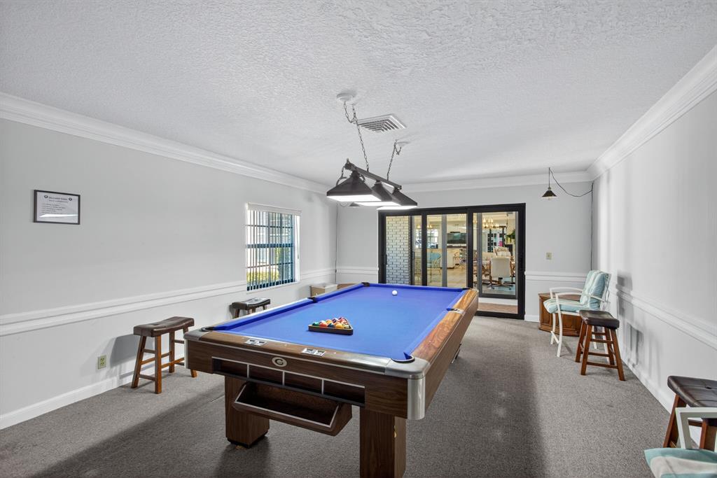 130 Cypress Club Drive, Unit 307 Pompano Beach, FL 33060 - Photo 35 of 35 a room with pool table and windows