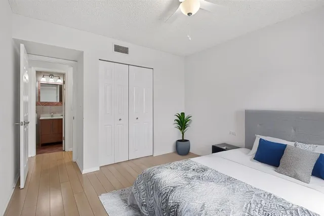 a bed room with a bed and a chandelier