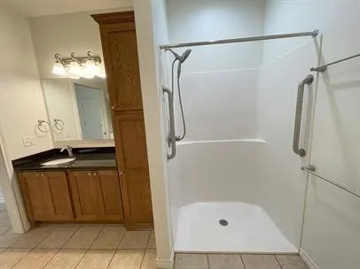 a bathroom with a shower and a sink