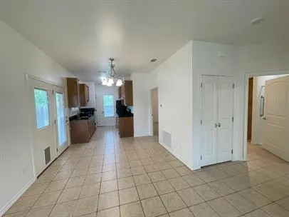 a large white kitchen with a refrigerator a sink and dishwasher