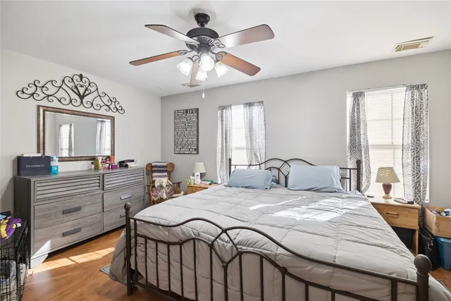 a bedroom with a large bed and a chandelier