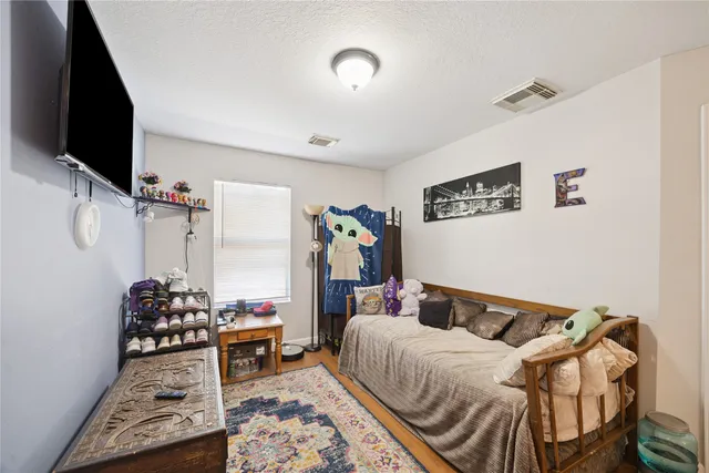 a bed room with a bed and a flat screen tv