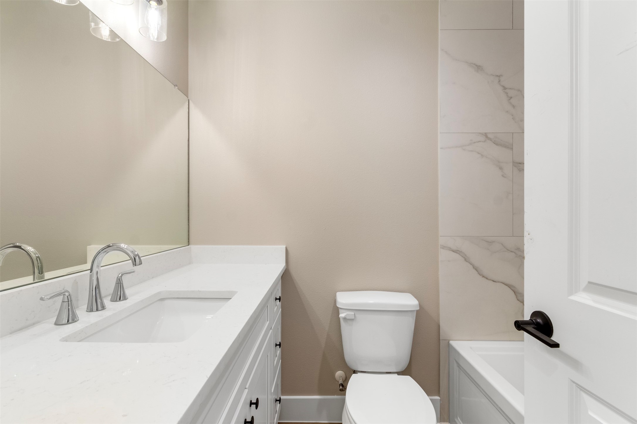 3152 South Cleveland Street Dayton, TX 77535 - Photo 13 of 22 a bathroom with a toilet sink and mirror