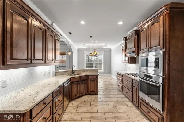 a kitchen with stainless steel appliances granite countertop a sink and stove