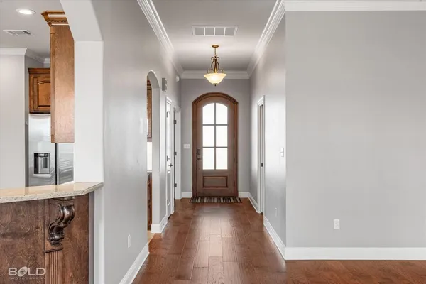 a view of a hallway with wooden floor and staircase