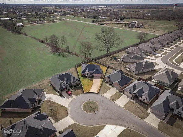 an aerial view of a house with outdoor space and lake view