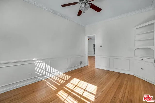a view of an empty room and wooden floor