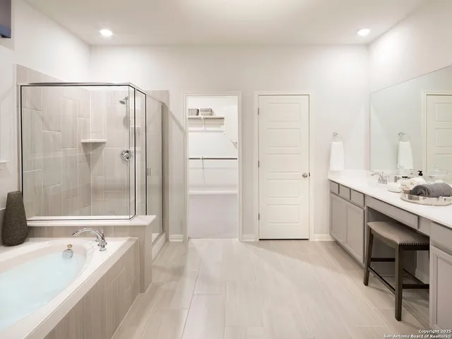 a spacious bathroom with a tub shower and sink