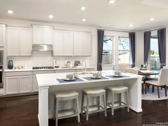 a kitchen with a sink stove and cabinets