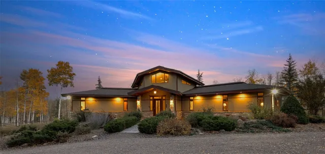 a view of a big yard with table and chairs under an umbrella