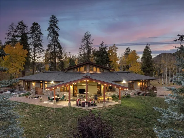 a view of a big yard with table and chairs under an umbrella