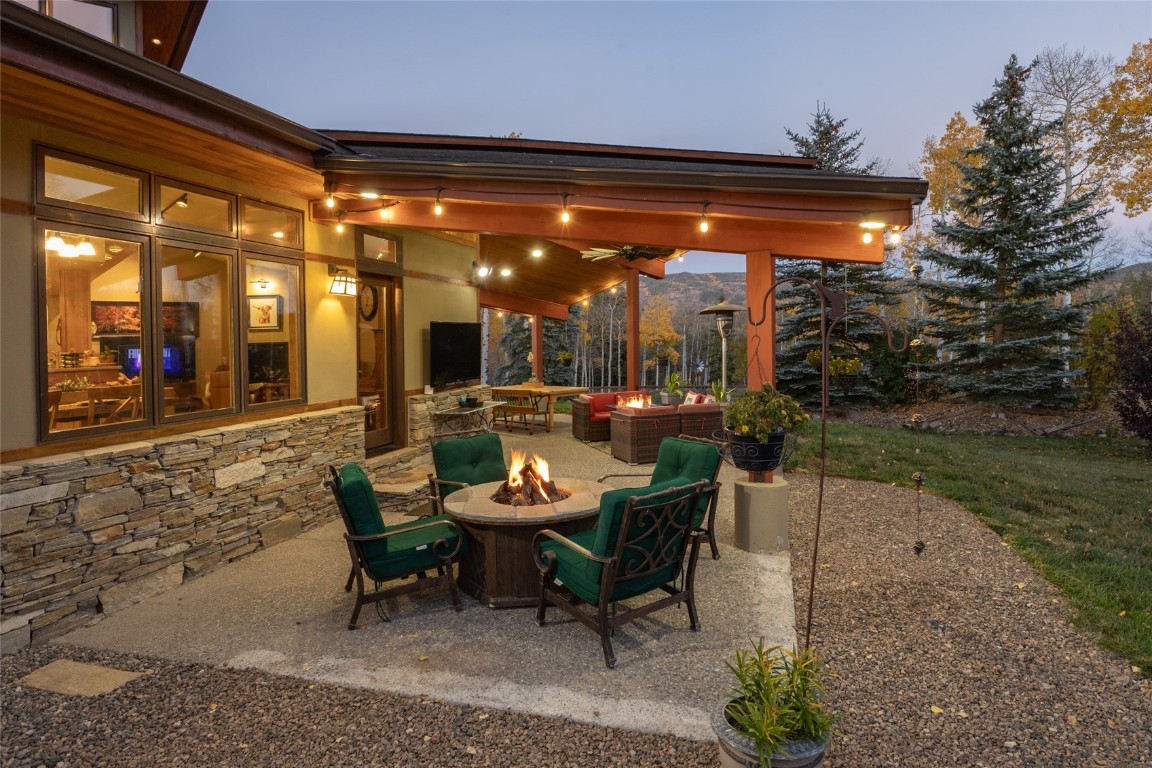 32350 Los Ranchos Road Oak Creek, CO 80467 - Photo 16 of 50 a view of a patio with a table and chairs under an umbrella