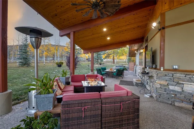a living room with fireplace furniture and a rug