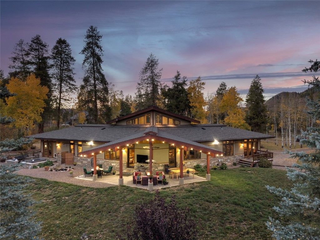 32350 Los Ranchos Road Oak Creek, CO 80467 - Photo 2 of 50 a view of a big yard with table and chairs under an umbrella