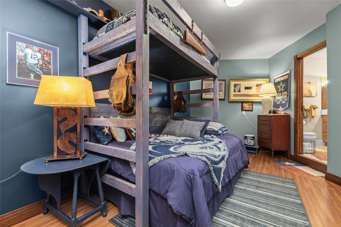 32350 Los Ranchos Road Oak Creek, CO 80467 - Photo 36 of 50 a bedroom with a bed and a chandelier