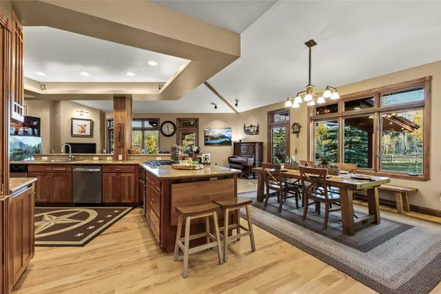 a view of a patio with a table and chairs under an umbrella