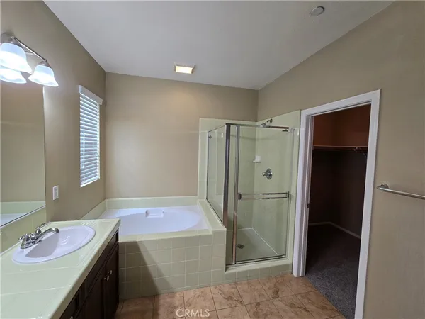 a view of an empty room with closet and wooden floor