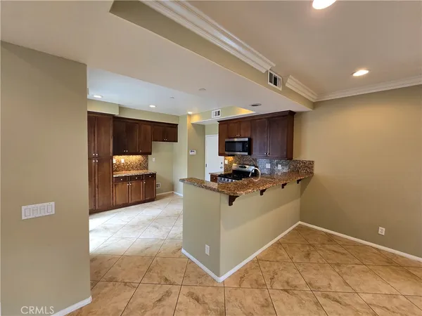 a kitchen with stainless steel appliances granite countertop a sink and cabinets