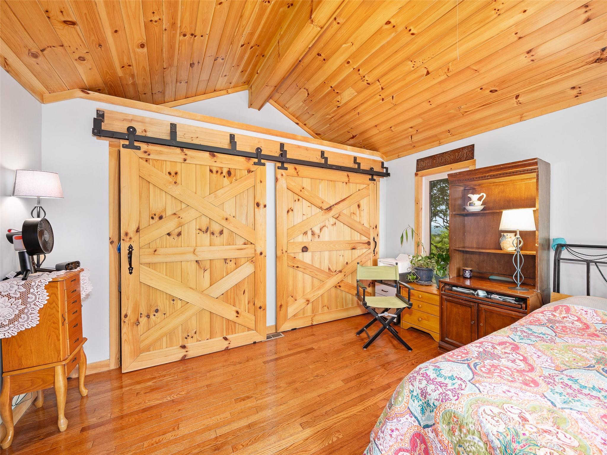 228 Continental Divide Road Spruce Pine, NC 28777 - Photo 14 of 48 a bedroom with furniture and a wooden floor
