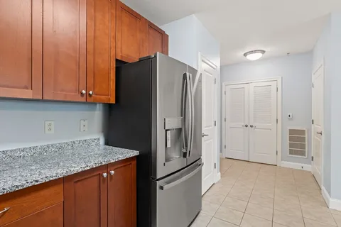 a kitchen with stainless steel appliances granite countertop a refrigerator and a stove