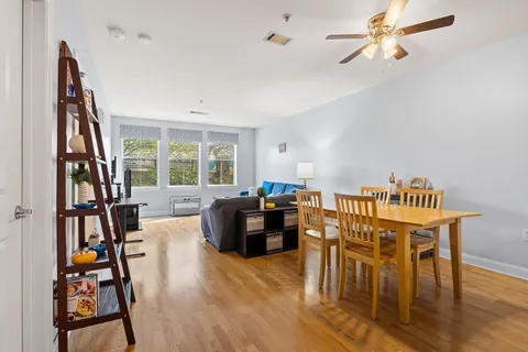a dining room with furniture and wooden floor