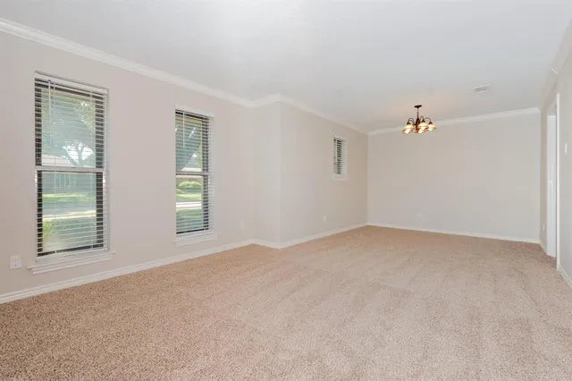 a view of a livingroom with an empty space and window