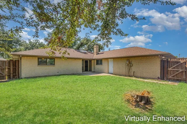 a backyard of a house with table and chairs
