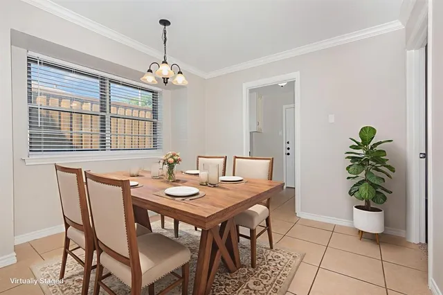 a dining room with furniture potted plants and wooden floor
