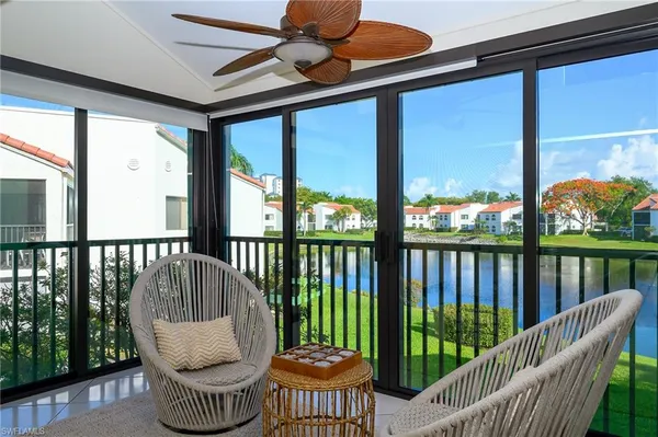 a view of a two chairs in the balcony