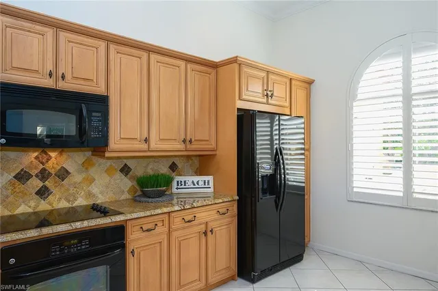 a kitchen with stainless steel appliances granite countertop a refrigerator sink and cabinets