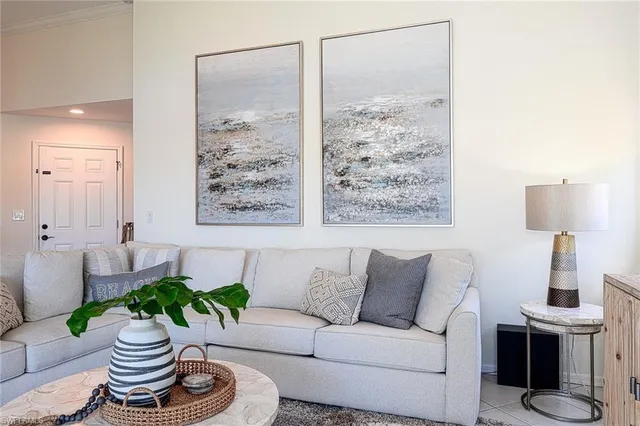 a living room with furniture and a potted plant