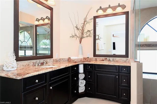 a bathroom with a sink vanity and mirror