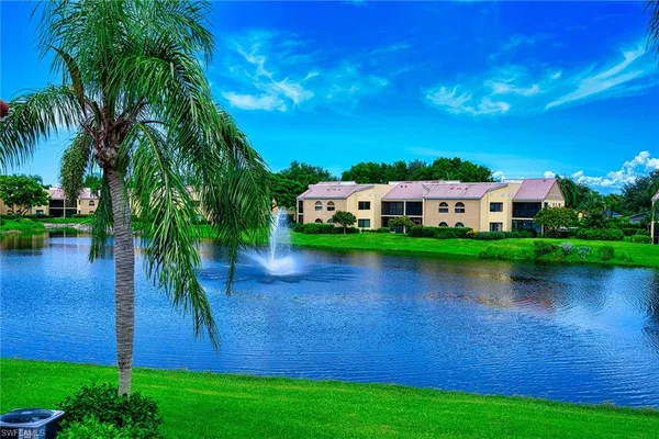 a view of a lake with houses in the background