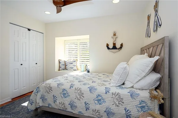 a bedroom with a bed and a window