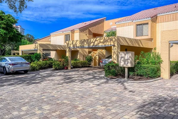 a view of a white house with a yard