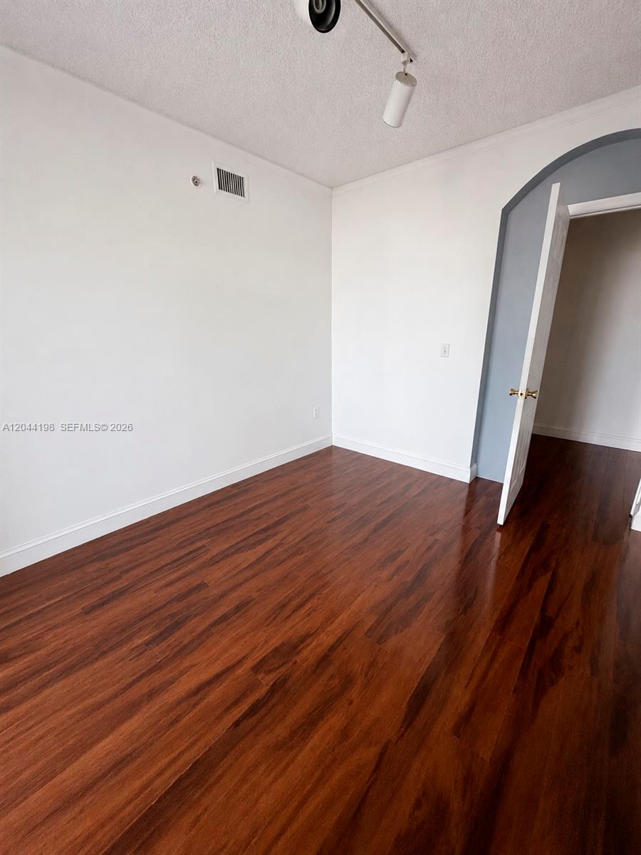 17145 North Bay Road, Unit 4307 Sunny Isles Beach, FL 33160 - Photo 15 of 35 a view of empty room with wooden floor